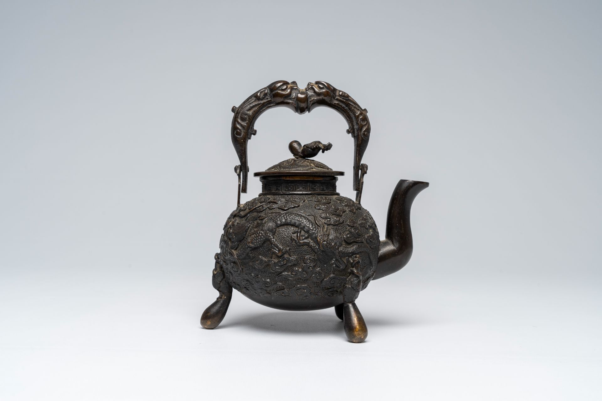 A Chinese tripod bronze teapot and cover with dragon relief design and double gourds, ca. 1900 - Image 3 of 8