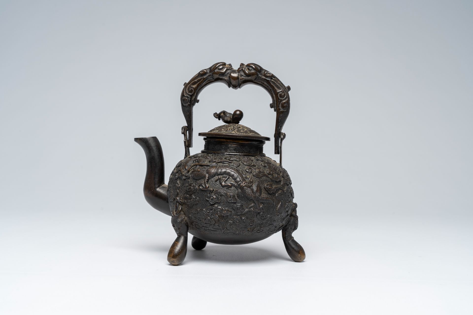 A Chinese tripod bronze teapot and cover with dragon relief design and double gourds, ca. 1900 - Image 5 of 8