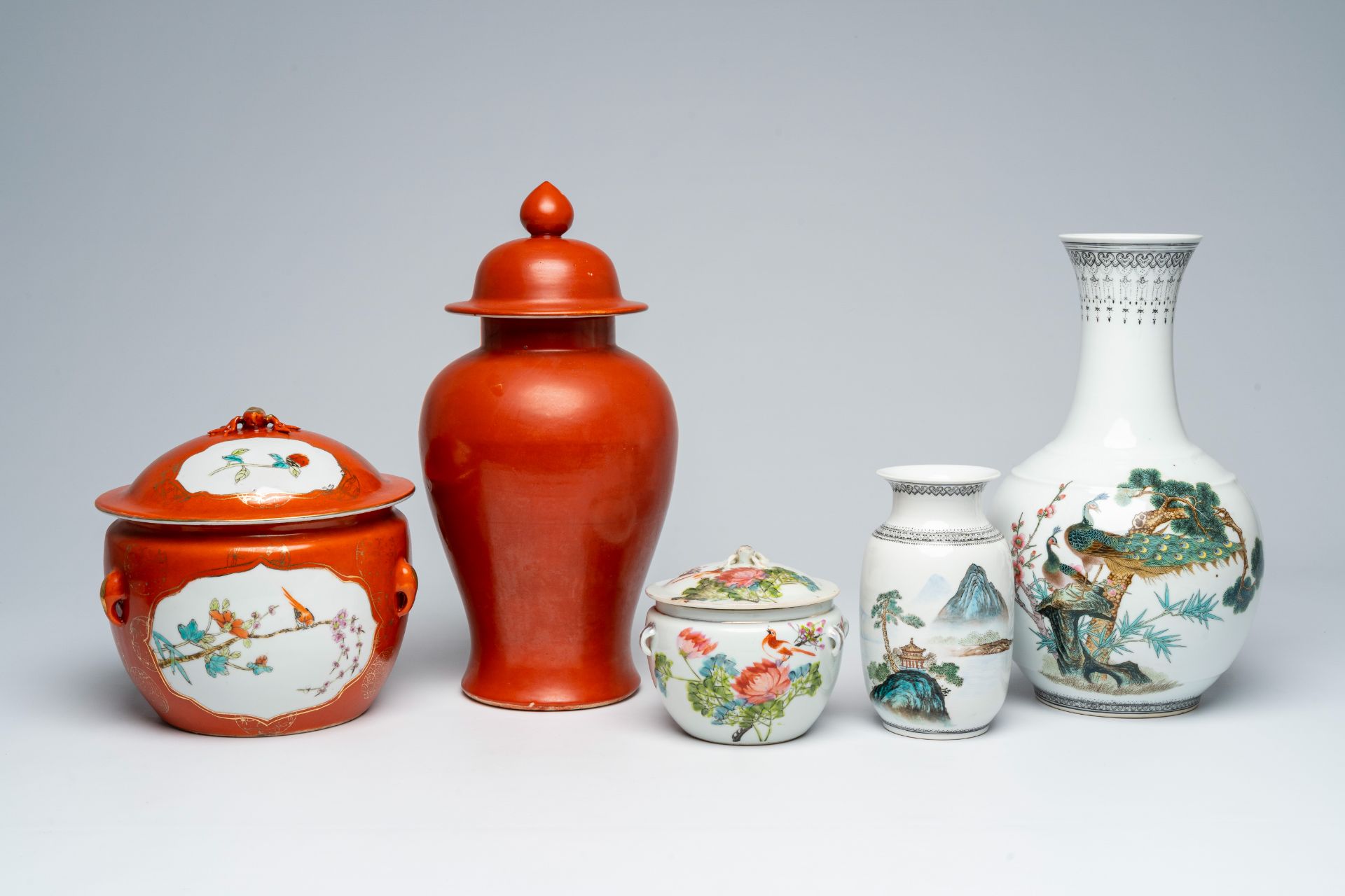 A varied collection of Chinese polychrome porcelain comprising two jars and covers and three vases,