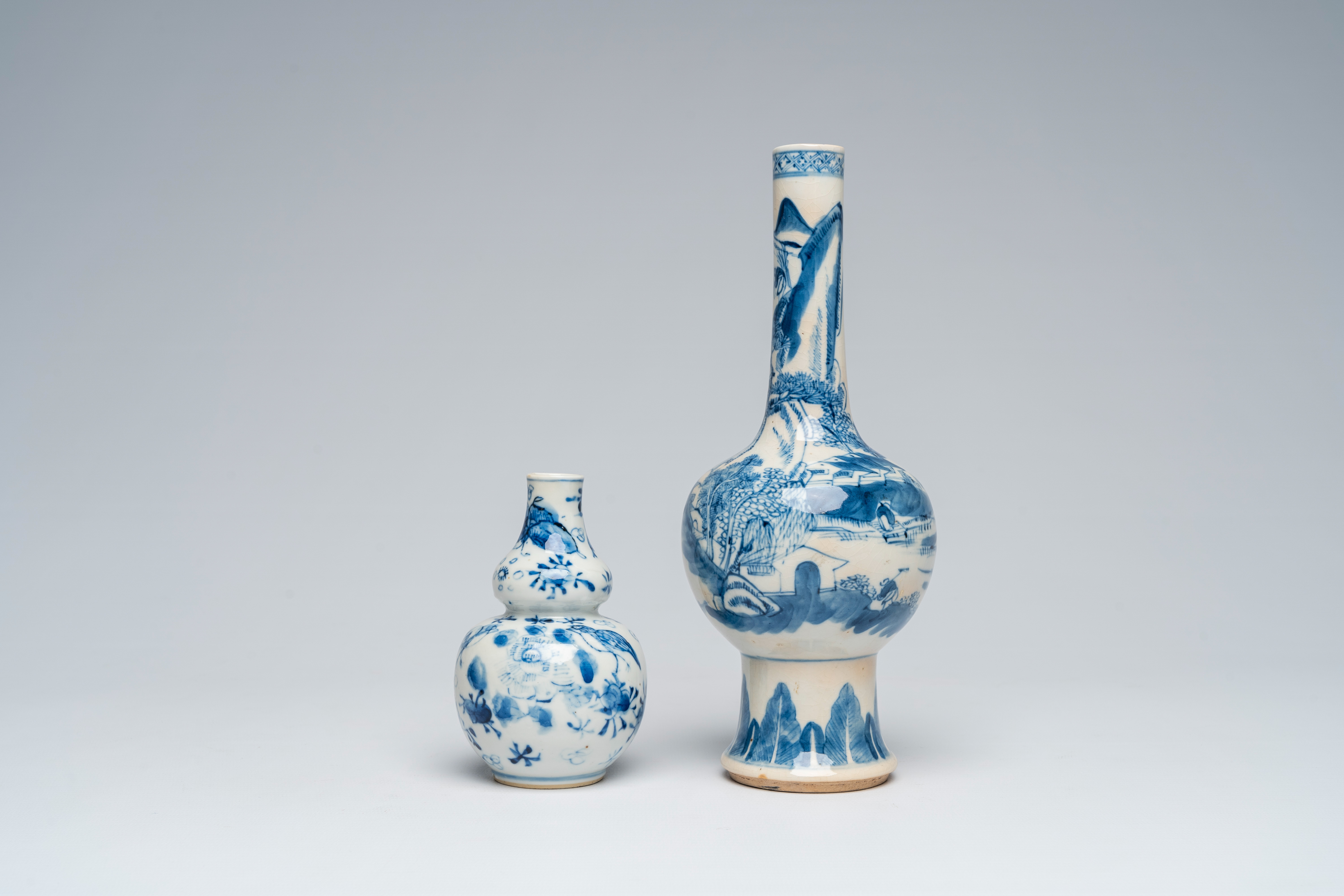 Two Chinese blue and white vases with an animated landscape and floral design, 18th/19th C.