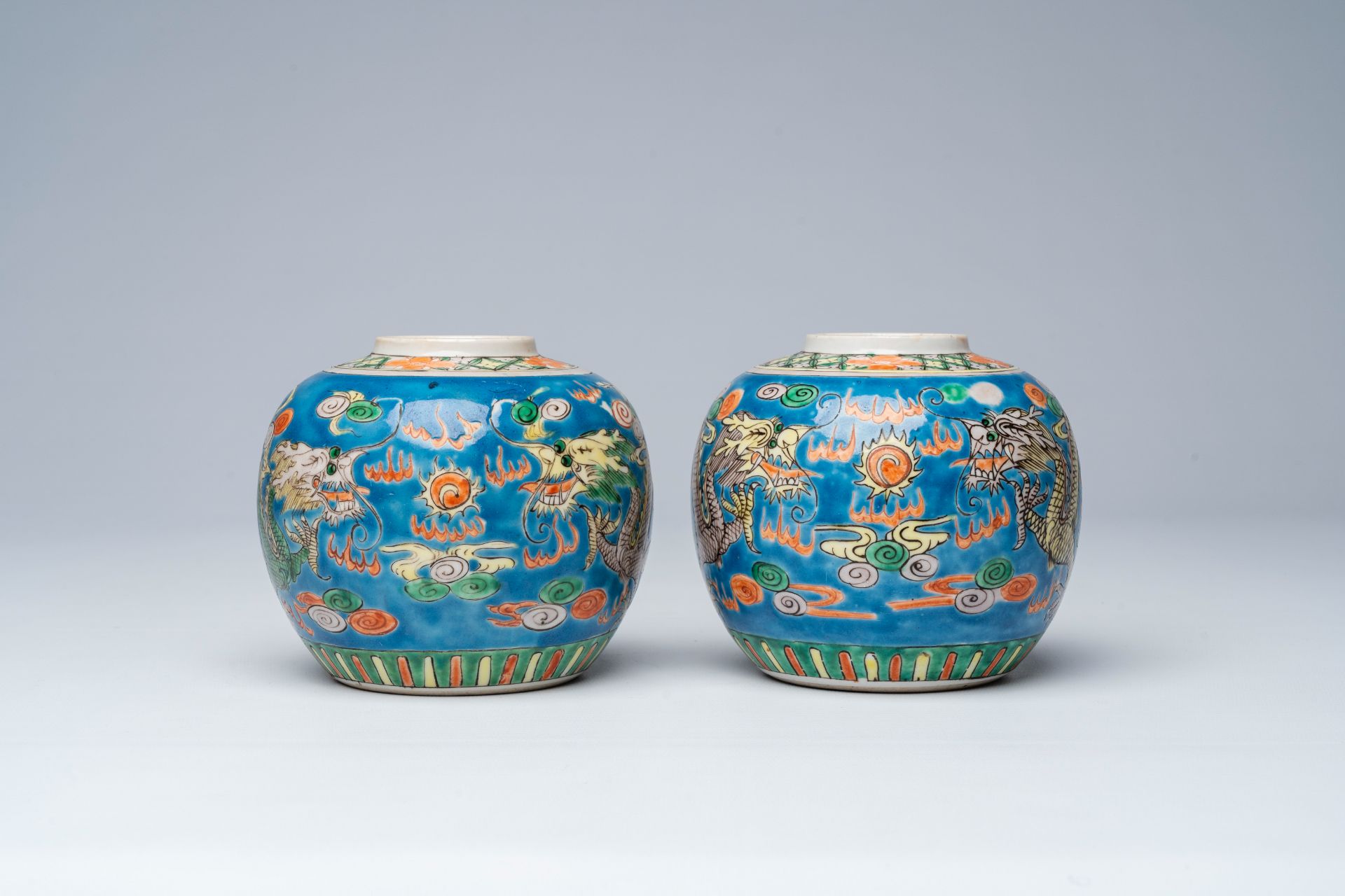 A pair of Chinese blue ground famille verte 'dragons chasing the pearl' ginger jars, 19th C. - Image 2 of 7