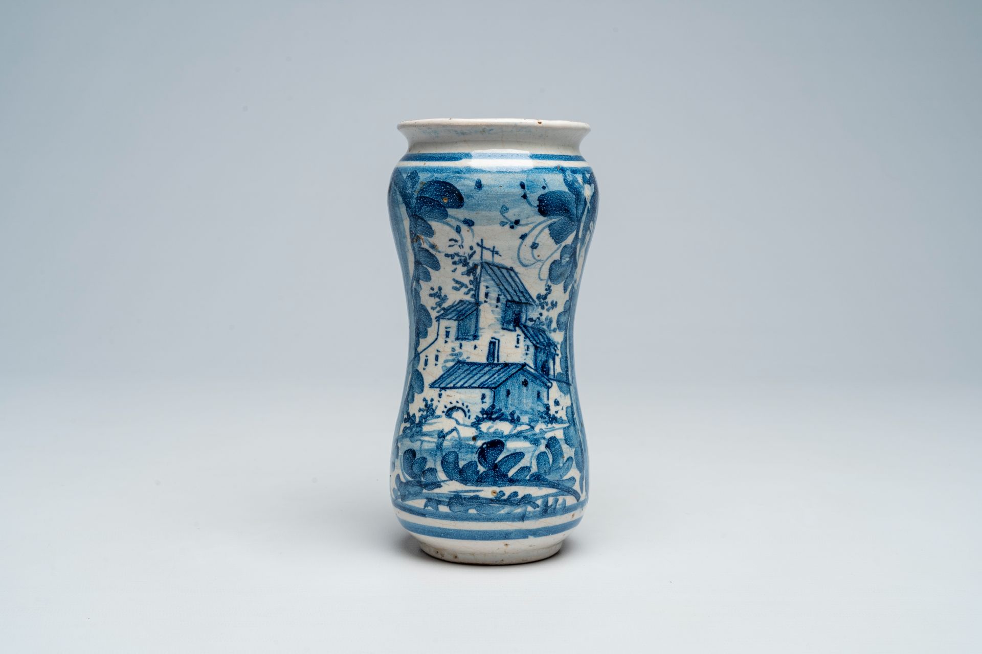 An Italian blue and white albarello with a landscape, dated 1710