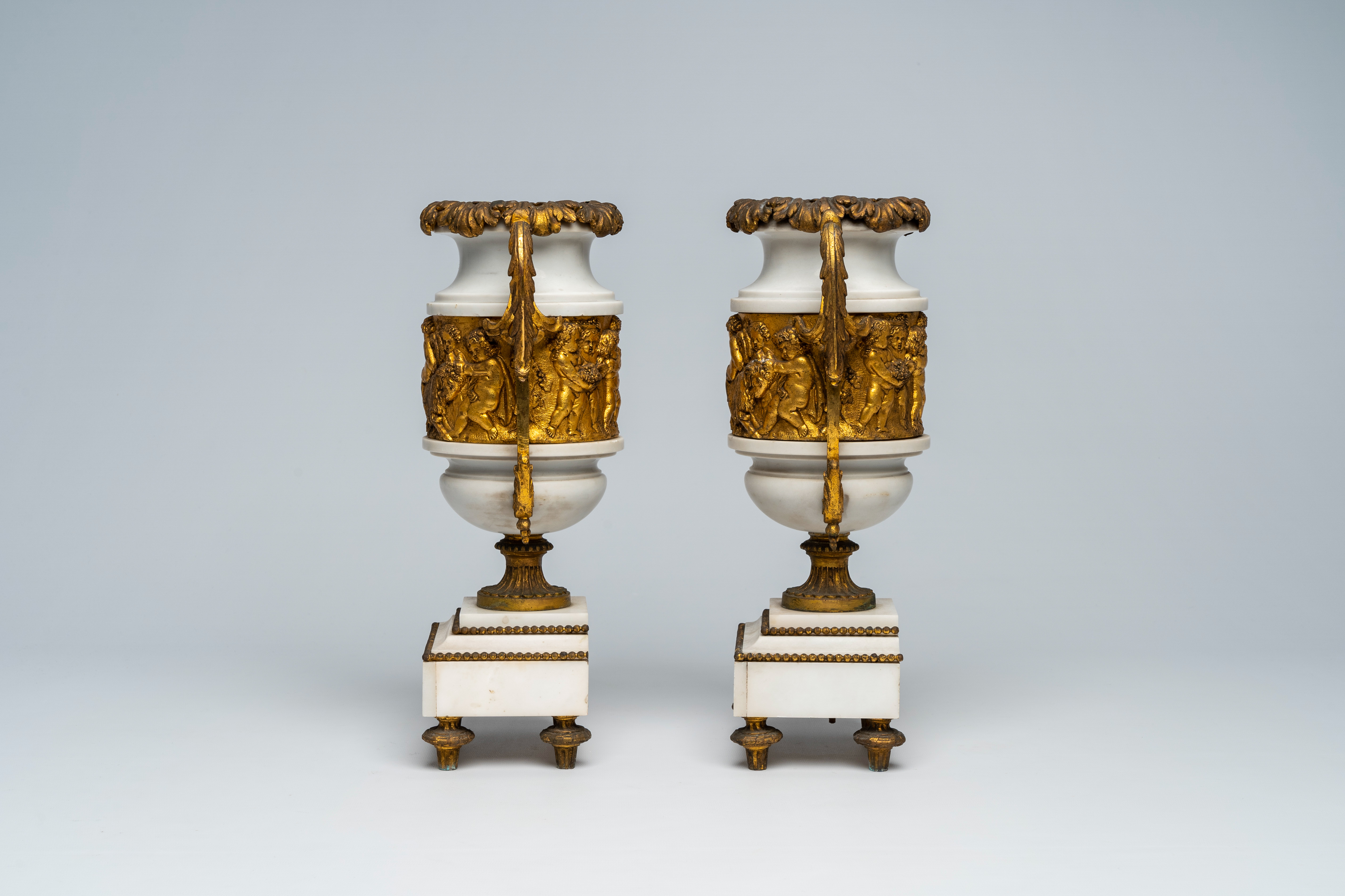 A pair of French gilt mounted white marble vases with relief design of putti, goats and Bacchus them - Image 2 of 7