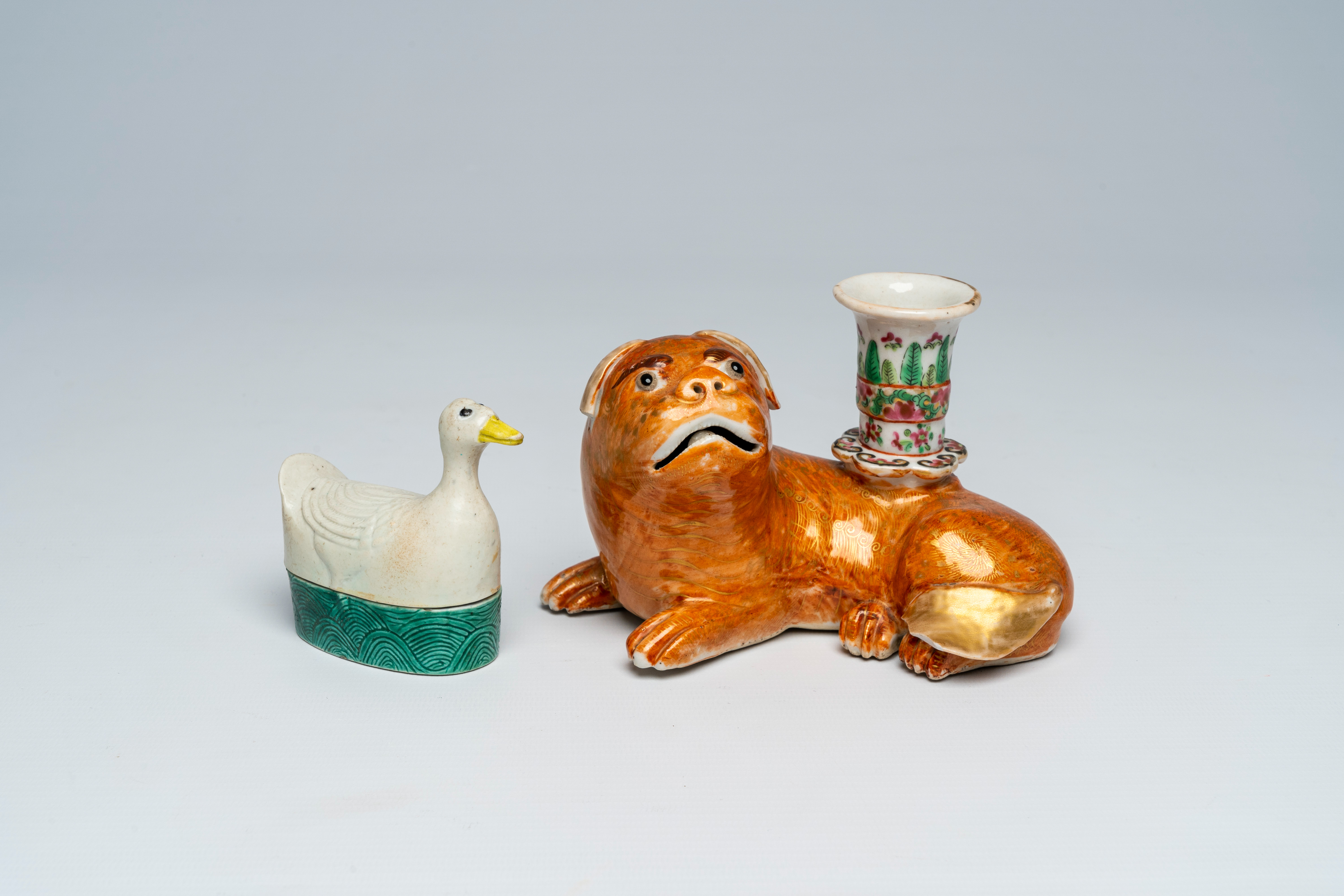 A Chinese Canton famille rose dog-shaped candlestick and a goose-shaped box and cover, 19th/20th C.