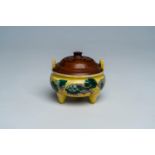 A Chinese verte biscuit yellow-ground 'Buddhist lions' tripod censer, 19th C.