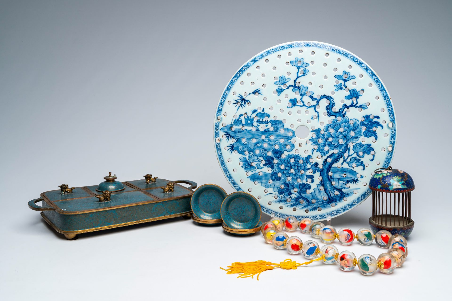 A Chinese blue and white strainer, a collection of cloisonne and a necklace of inside painted glass