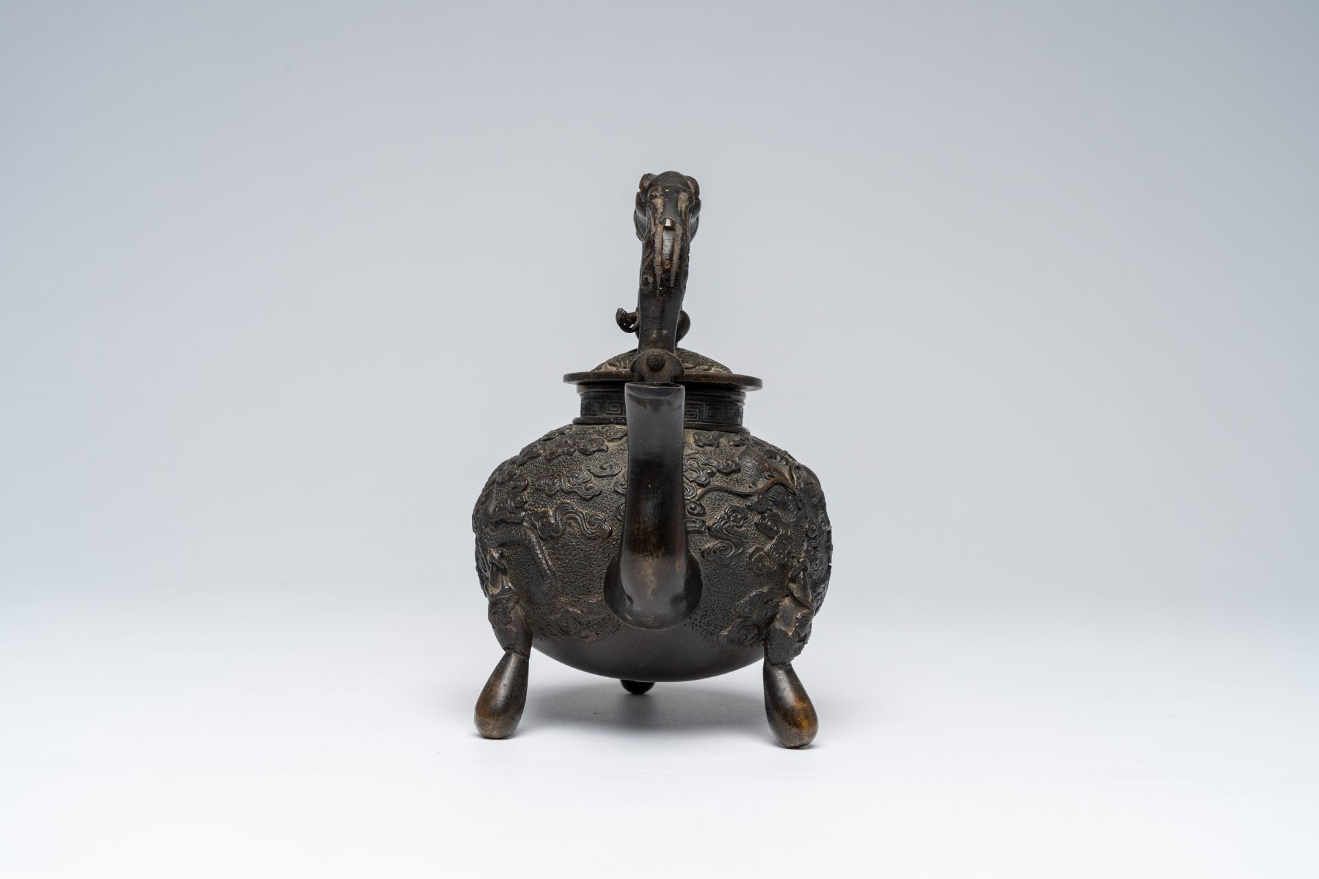A Chinese tripod bronze teapot and cover with dragon relief design and double gourds, ca. 1900 - Image 4 of 8