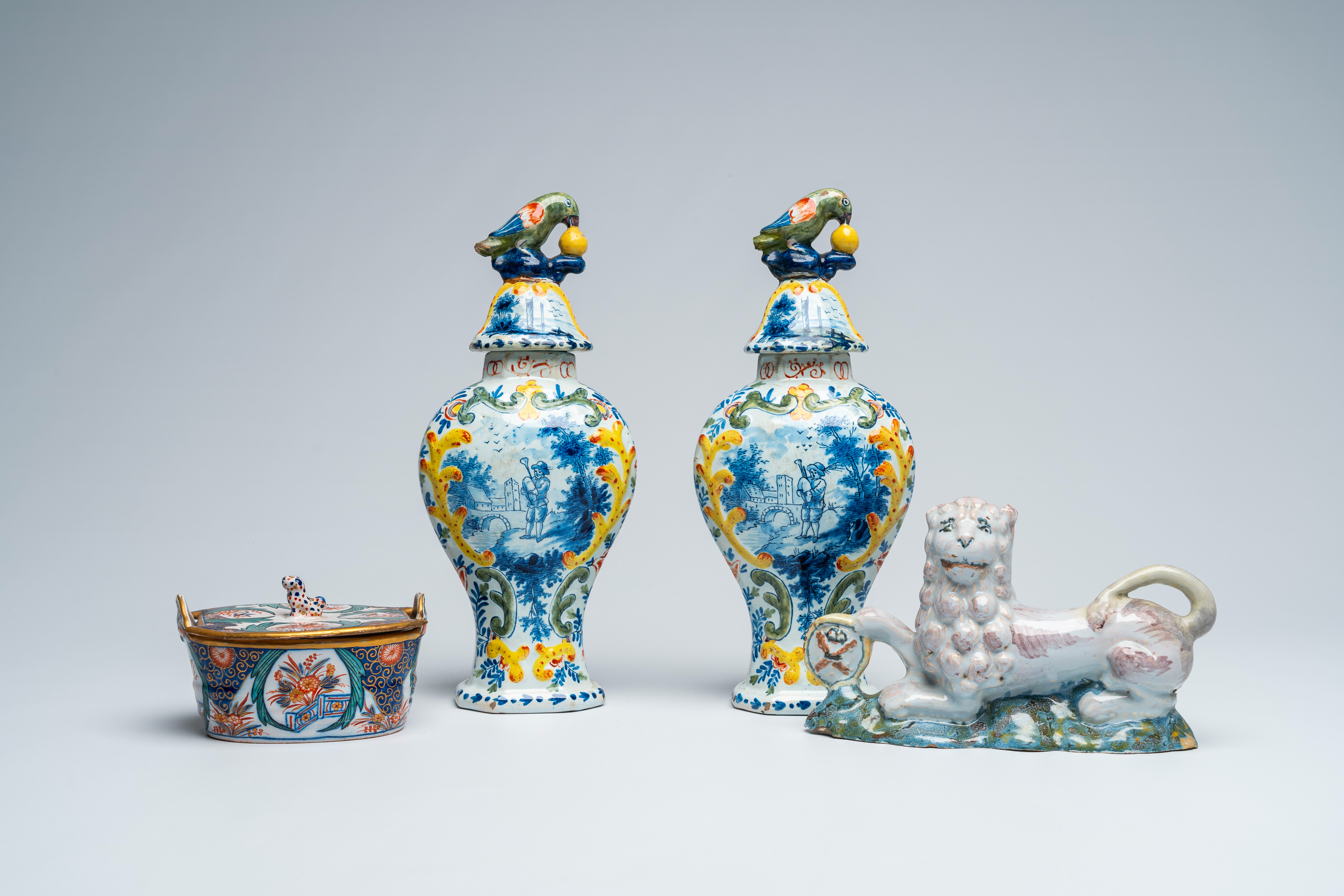 A pair of polychrome Delft vases and covers, a butter tub and a reclining lion, 18th and 19th C.