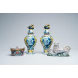 A pair of polychrome Delft vases and covers, a butter tub and a reclining lion, 18th and 19th C.