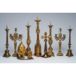 A varied collection of bronze and brass candlesticks, a thurible and an Art Deco crucifix, 19th/20th