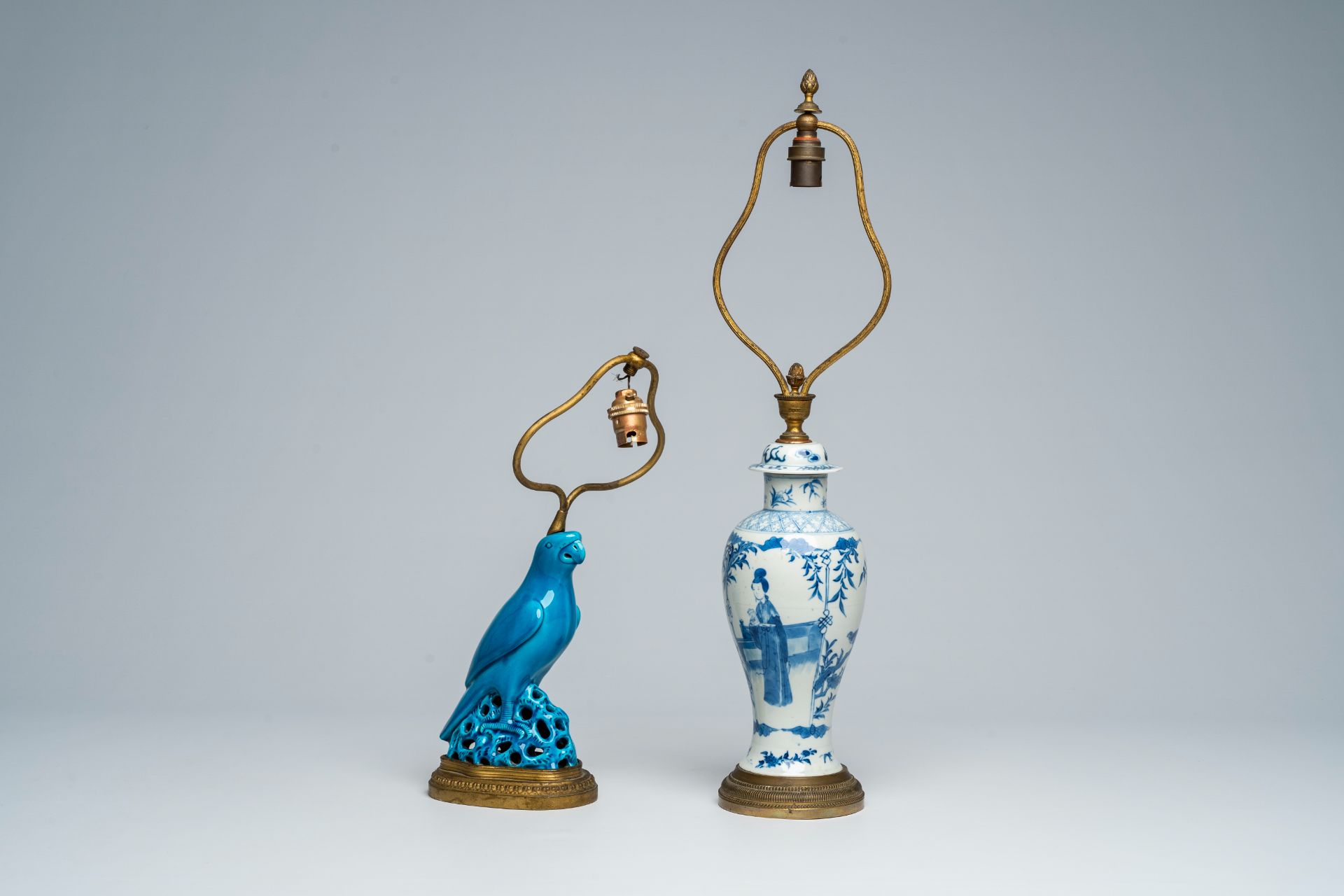 A Chinese blue and white vase and cover and a turquoise-glazed model of a parrot mounted as lamps, 1