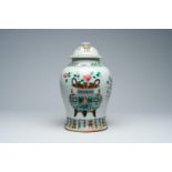 A Chinese famille rose vase and cover with antiquities and floral design, 19th C.
