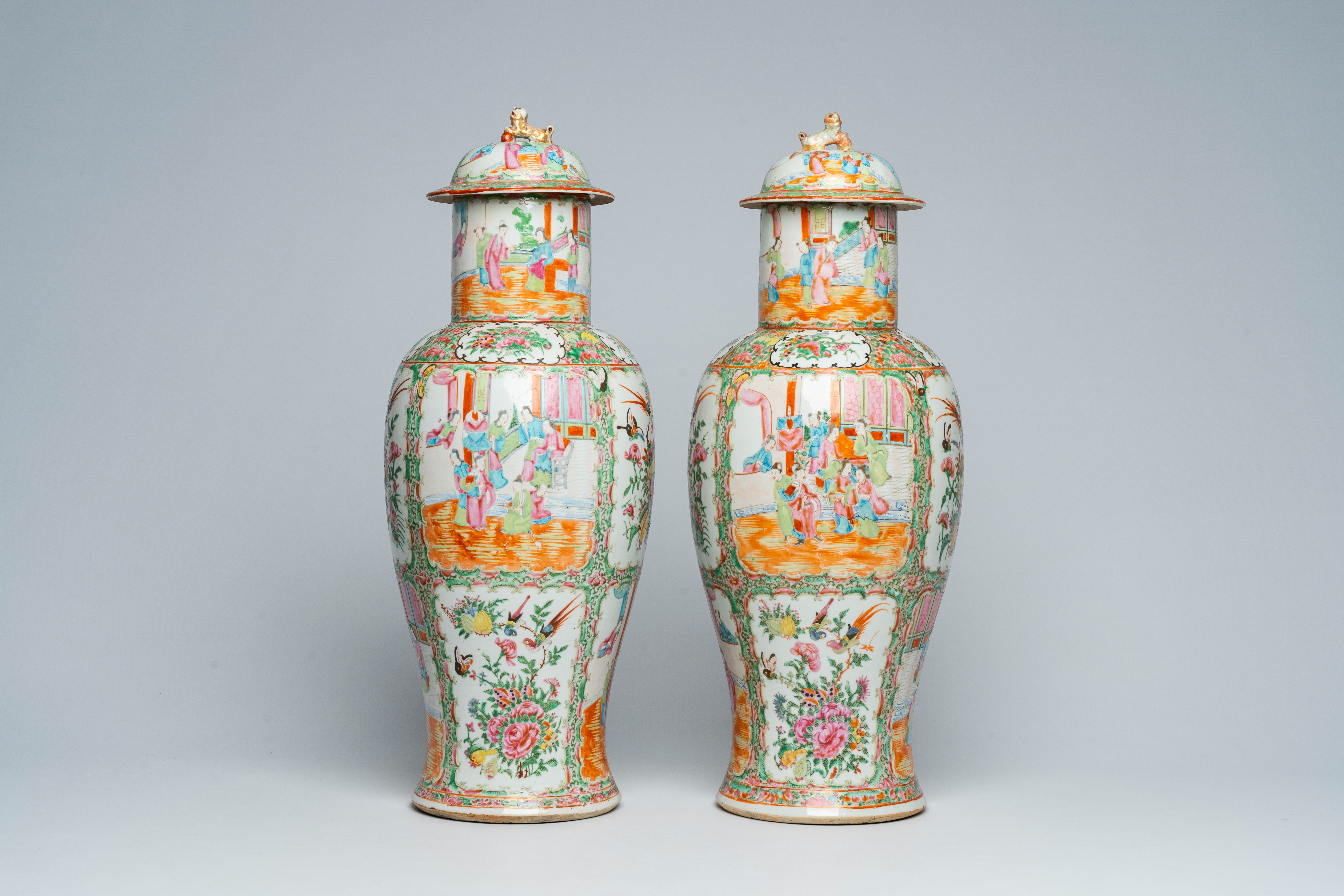 A pair of Chinese Canton famille rose vases and covers with palace scenes and floral design, 19th C.