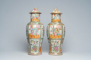 A pair of Chinese Canton famille rose vases and covers with palace scenes and floral design, 19th C.