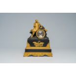 A French gilt and patinated bronze mantel clock topped with a resting Napoleon Bonaparte, 19th C.