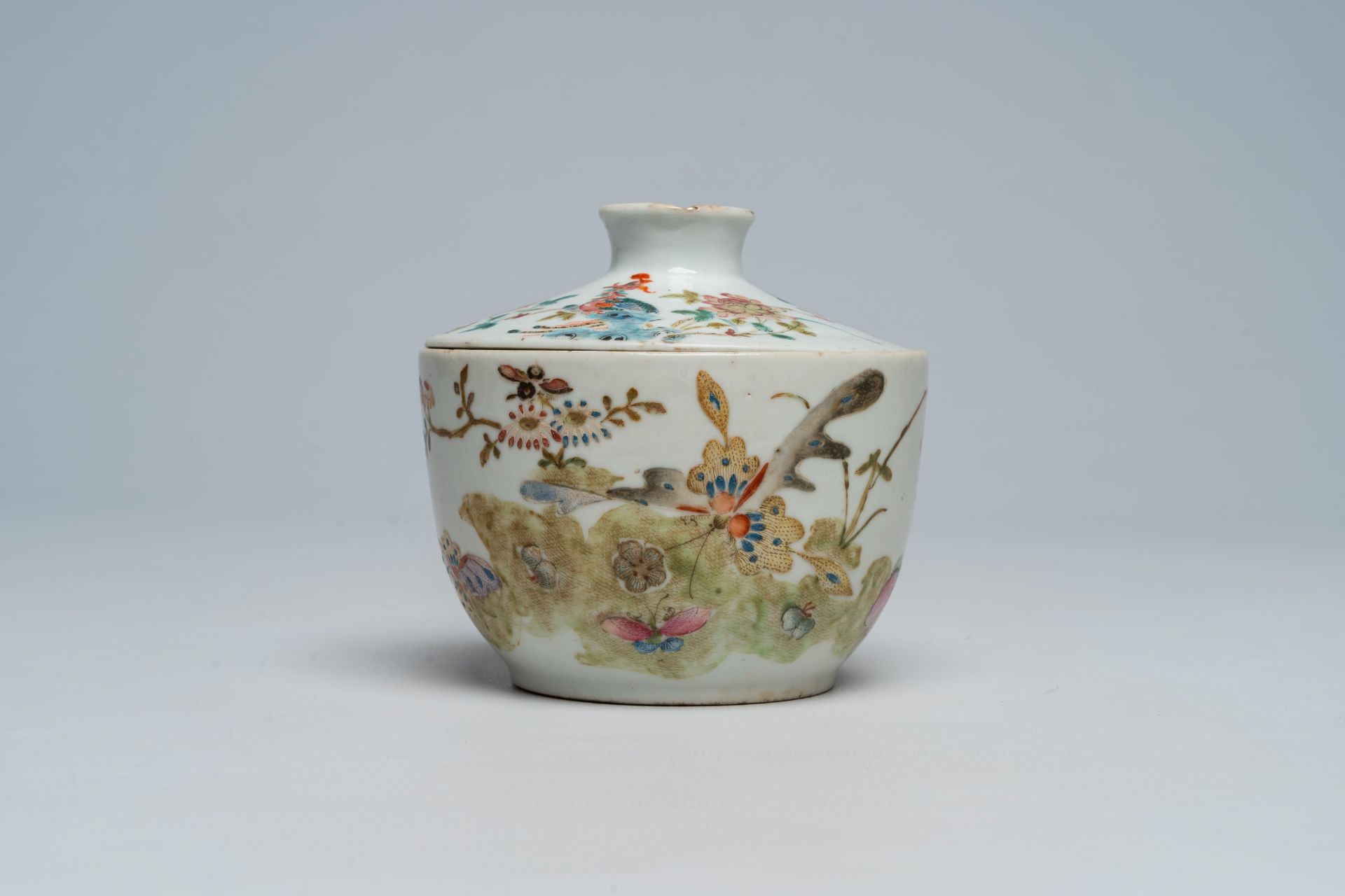 A Chinese famille rose bowl and cover with a phenix, butterflies and floral design, Tongzhi mark and