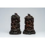A pair of Chinese wood brush pots with relief design and a pair of open worked stands and covers, 19