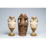 A pair of polychrome decorated biscuit Royal Dux baluster vases and a patinated HabÃ¶ck vase with fl