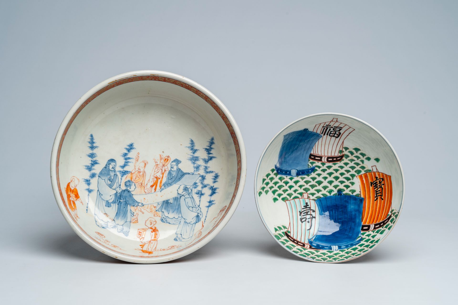 A Japanese Imari 'sages' bowl and a bowl with sailing ships and phoenixes, Meiji, 19th C.