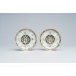 A pair of Chinese famille rose and grisaille 'armorial' saucers, Qianlong