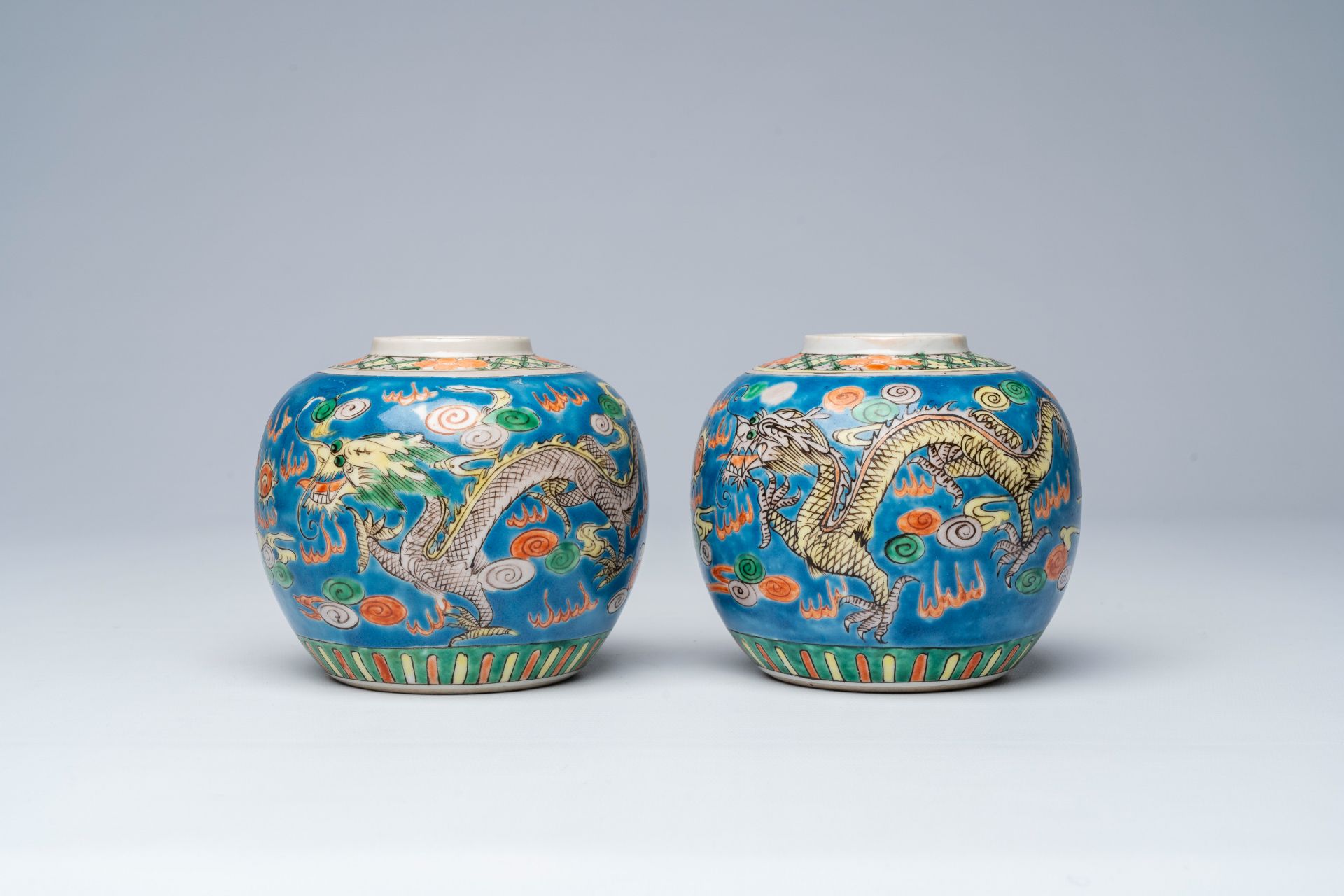 A pair of Chinese blue ground famille verte 'dragons chasing the pearl' ginger jars, 19th C. - Image 3 of 7