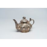 An Anglo-Indian colonial silver teapot with a cobra, animated medallions and crowned with an elephan