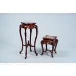 Two Chinese open worked carved wood stands with marble and dreamstone top, 20th C.