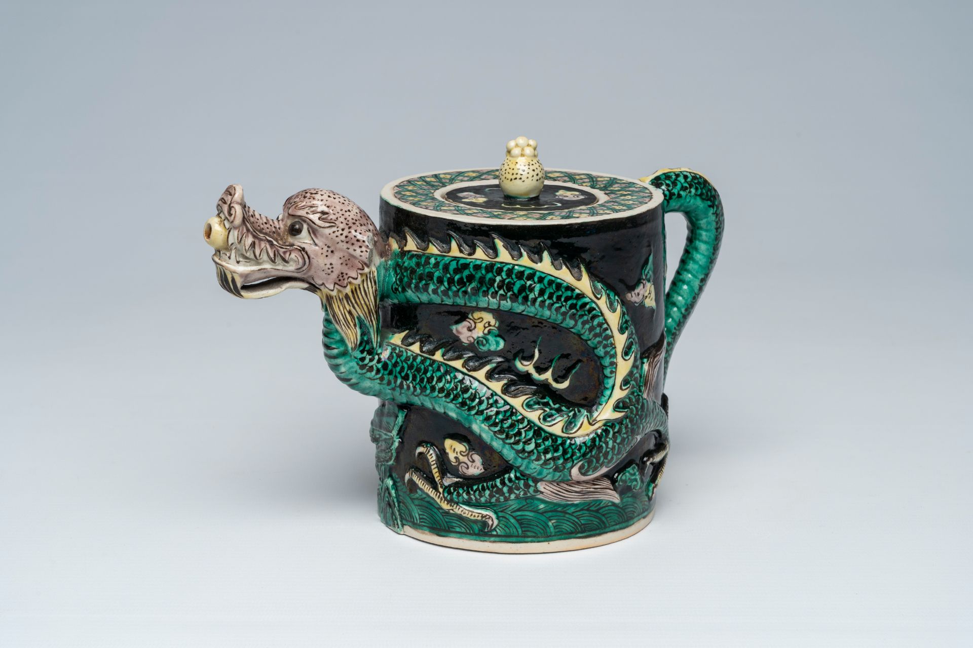 A Chinese famille noire dragon-shaped teapot with relief design, 19th C.