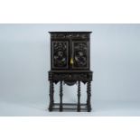 An ebonised wood two-door cabinet on stand with portrait medallions, 19th C.