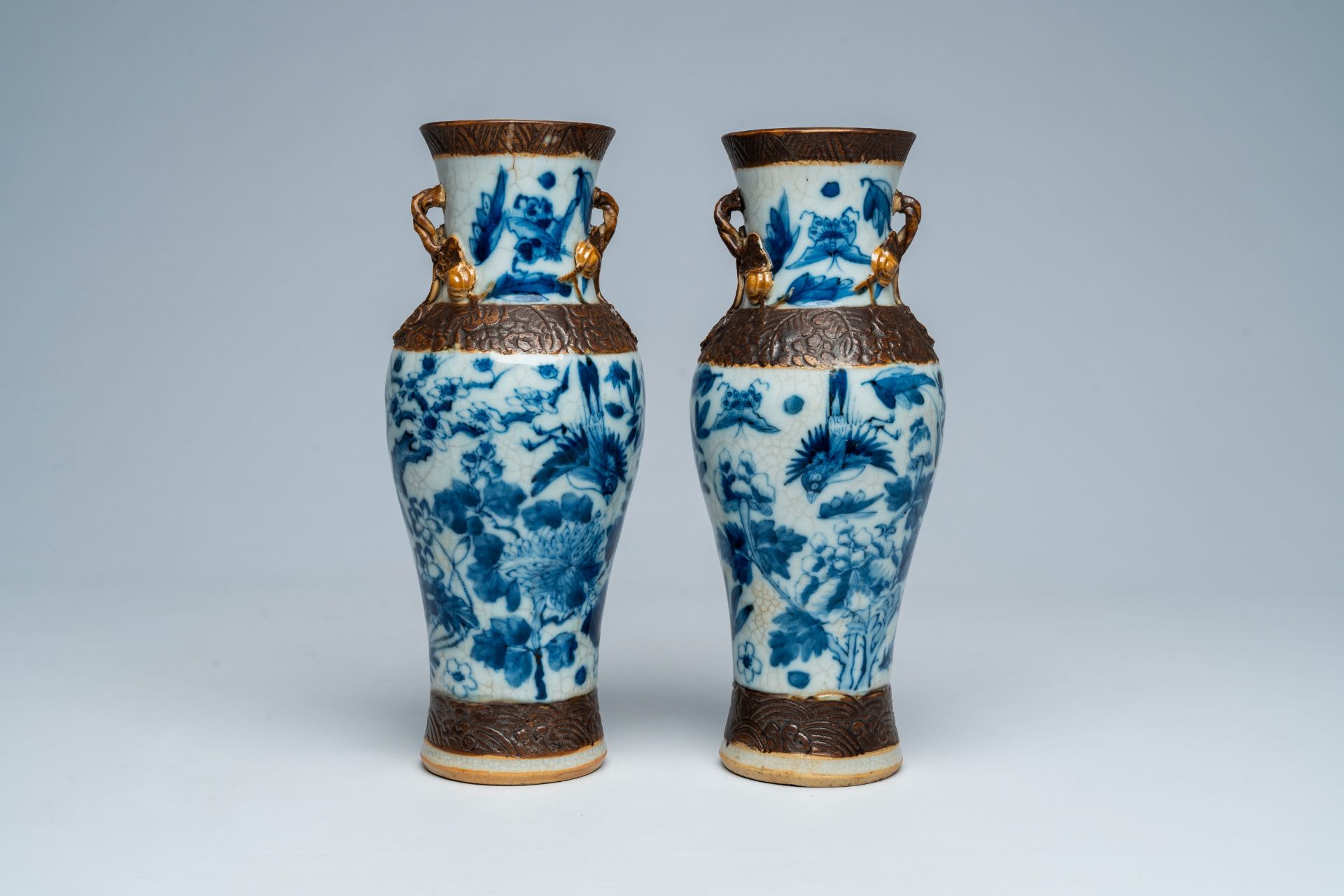 A pair of Chinese Nanking crackle glazed blue and white vases with birds and butterflies among bloss - Image 3 of 6