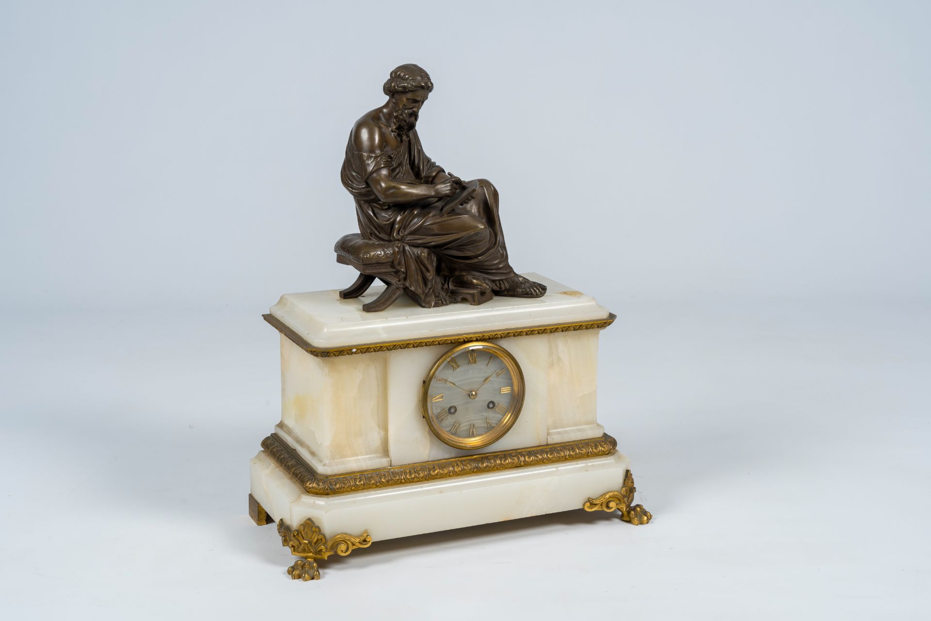 A French gilt and patinated bronze mounted white onyx mantel clock with a legist, 19th C. - Image 2 of 10