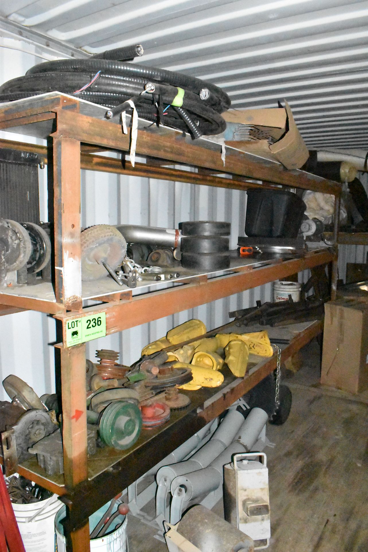 LOT/ REMAINING CONTENTS OF CONTAINER CONSISTING OF SPARE PARTS, FLY WHEELS, WIRE, ROLLERS AND BUCKET