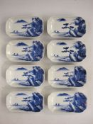Set of eight Chinese porcelain oblong dishes, each individually painted in underglaze blue with