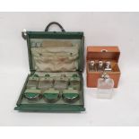 Early 20th century leather cased travelling set of four glass flasks with glass stoppers and EPNS