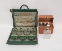 Early 20th century leather cased travelling set of four glass flasks with glass stoppers and EPNS