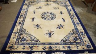Large Chinese cream ground superwash carpet with central floral motif and blue and floral border 376