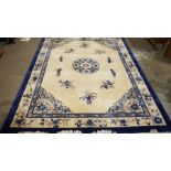 Large Chinese cream ground superwash carpet with central floral motif and blue and floral border 376