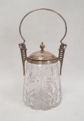 An early 20th century cut glass and silver-plate mounted jar and cover, with silver-plated loop