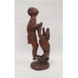 Tribal hardwood carving, group of man and animal, signed to base K Ukando, 41cm high