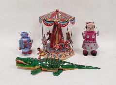 German tinplate toy roundabout, clockwork toy robot, another and a tinplate crocodile (4)