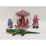 German tinplate toy roundabout, clockwork toy robot, another and a tinplate crocodile (4)