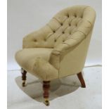 Reproduction buttonback armchair on baluster supports and castors