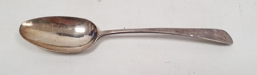 A Georgian silver serving spoon and a collection of silver-plated and metal flatware, the first
