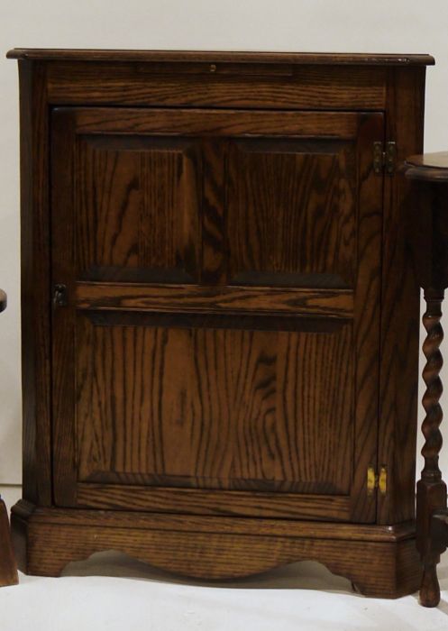 20th century oak corner cupboard by Jaycee with candle slide above panel door, bracket feet, 87cm