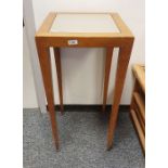 American Donghia occasional table with beech effect finish, tapering supports and castors and a