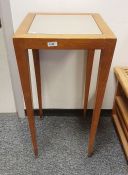 American Donghia occasional table with beech effect finish, tapering supports and castors and a