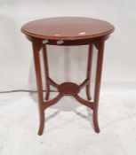 Circular occasional table on square section supports