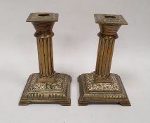 Victorian brass table candlesticks, each square with reeded columns and on stepped square bases,