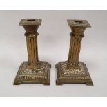 Victorian brass table candlesticks, each square with reeded columns and on stepped square bases,
