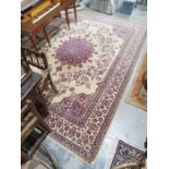 European ivory ground carpet with large central floral arabesque surrounded by floral designs with a